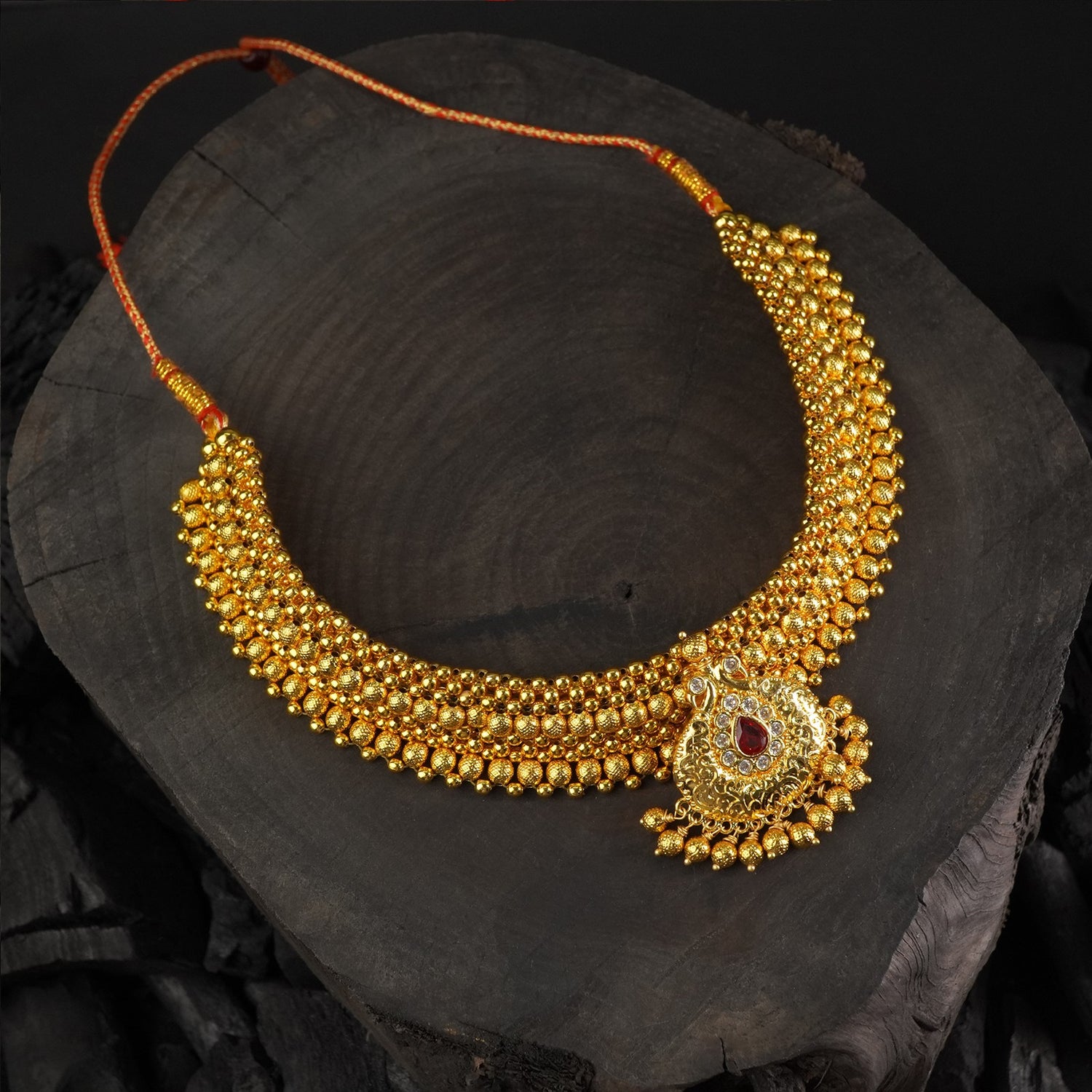 broad kolhapuri thushi design with an stone studded peacock pendant