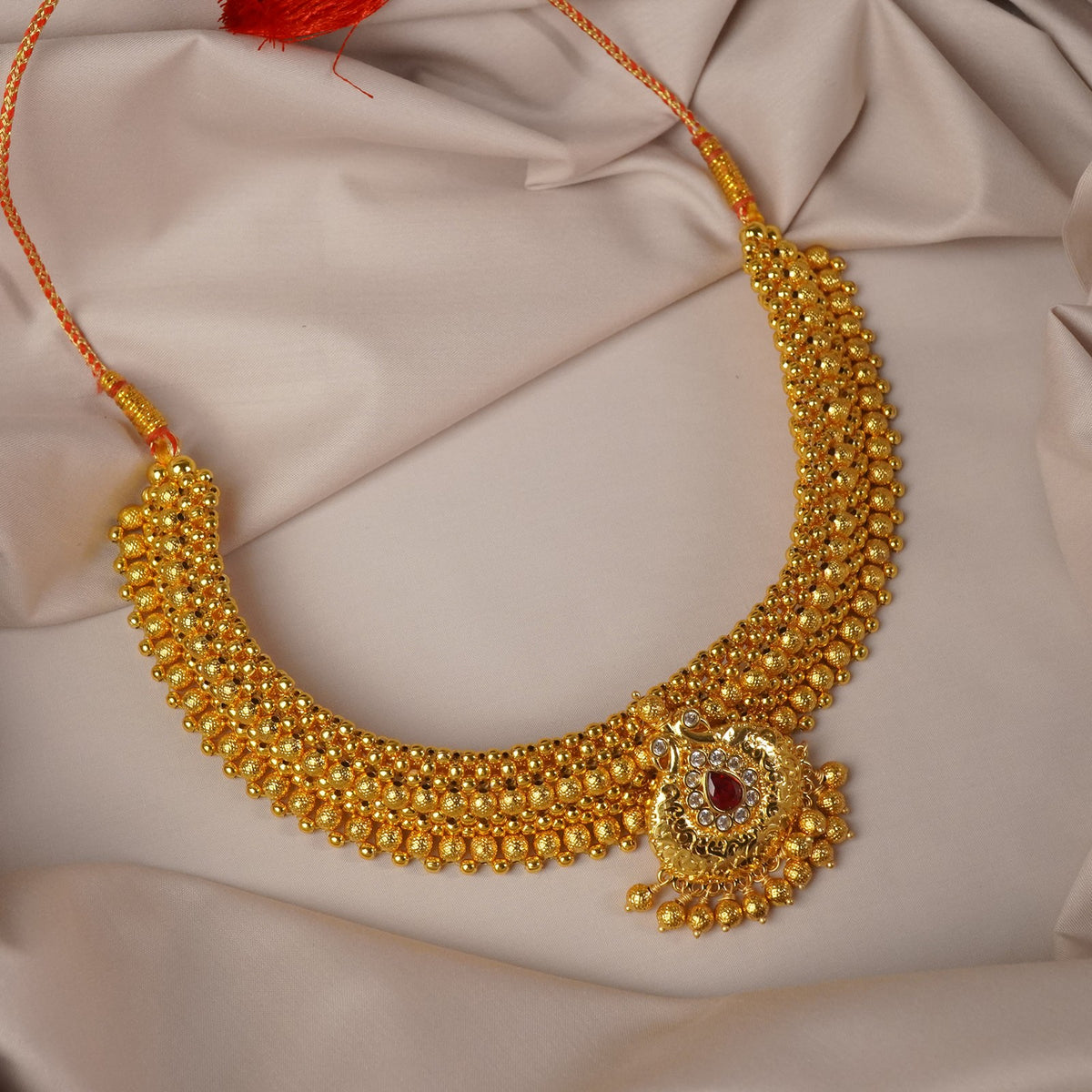 broad kolhapuri thushi design with an stone studded peacock pendant